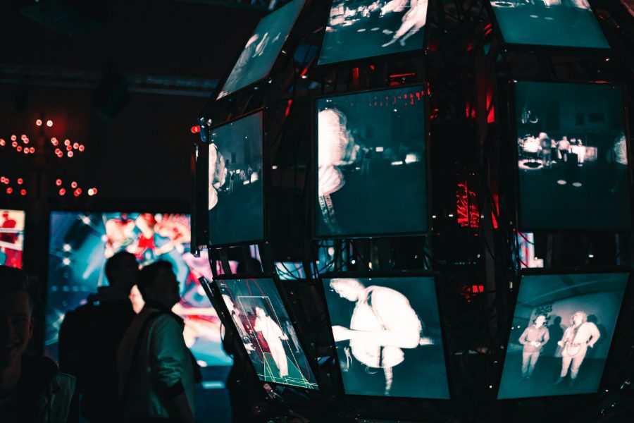 Wall of screens showing media coverage